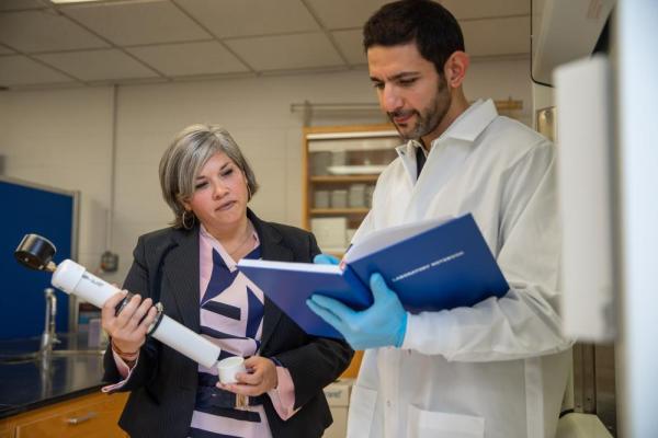 Researchers with equipment in a lab